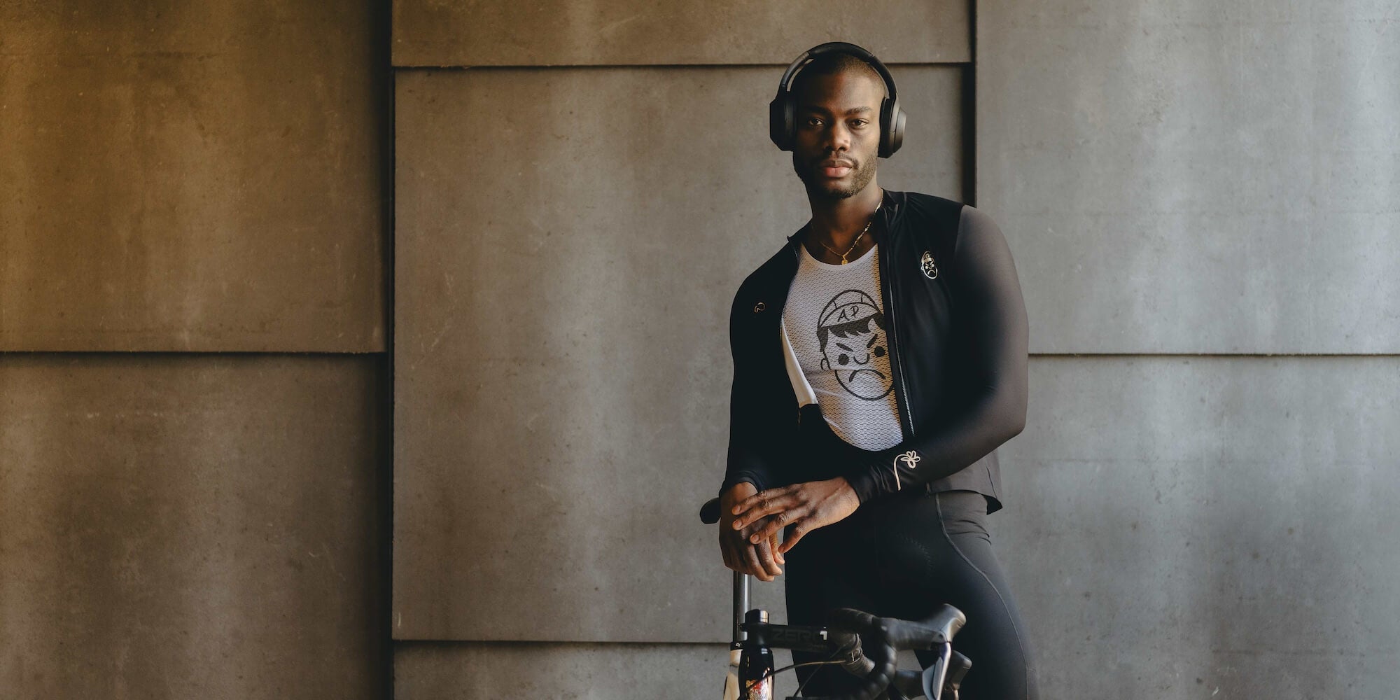 A male cyclist wearing angry pablo cycling clothing and headphones